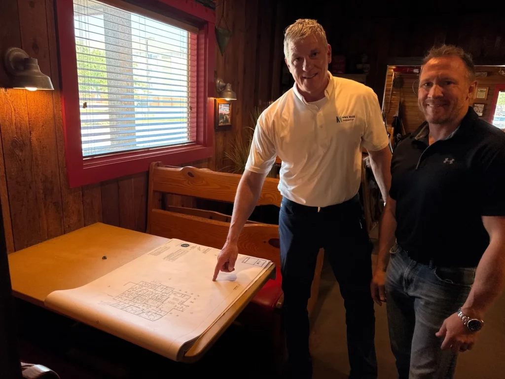 NWA Mold Inspector Brian Suggs discusses findings with business owner.